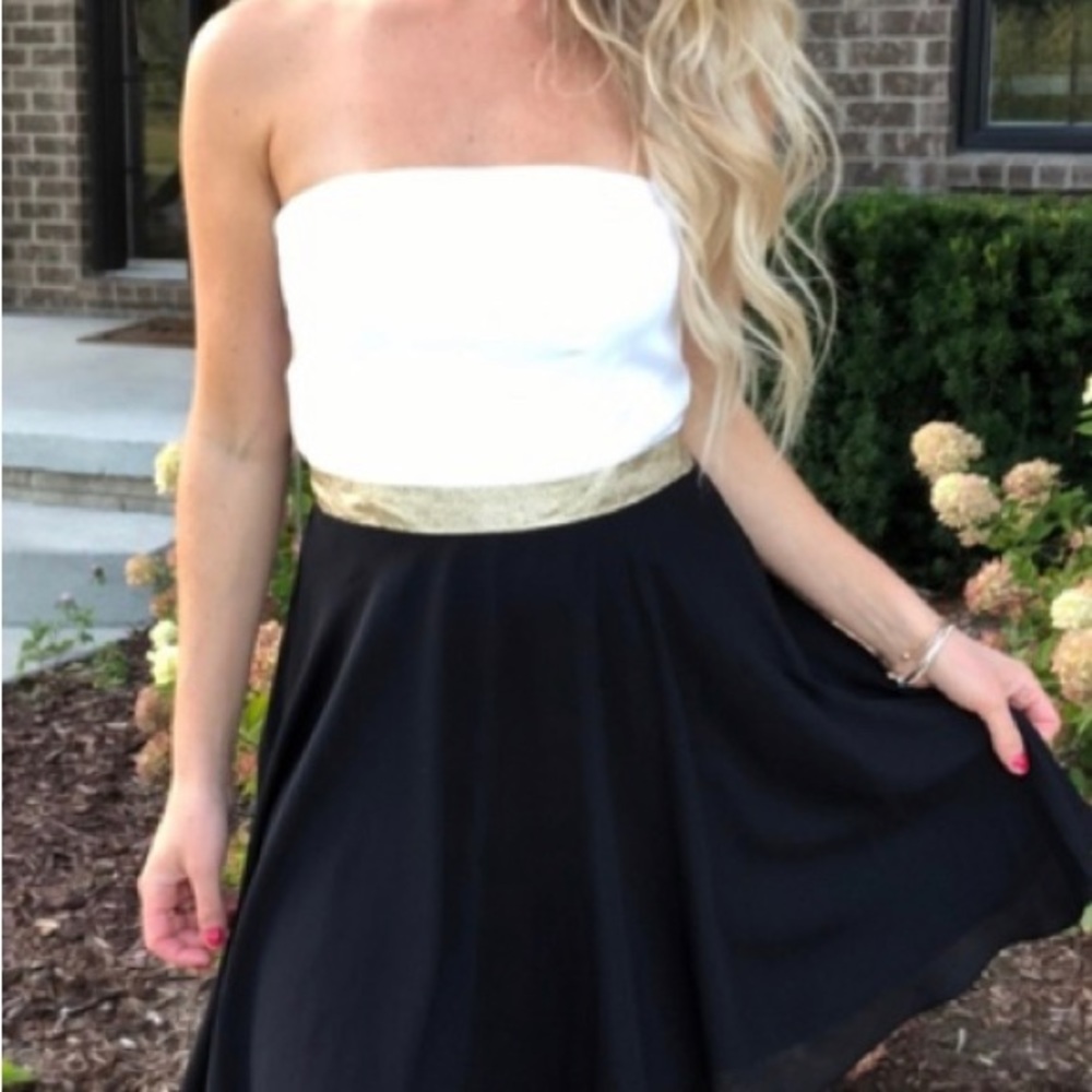 Stunning black and white strapless dress with gold accent at waist